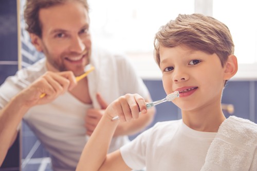 boy and dad brushing teeth