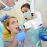 woman receives dental x-ray