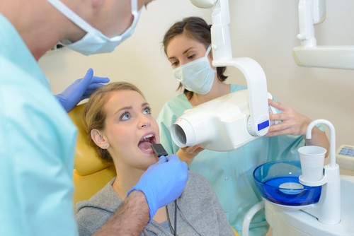 woman receives dental x-ray